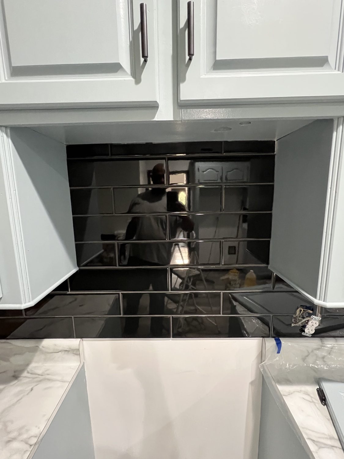 Finished kitchen with black subway-tile backsplash