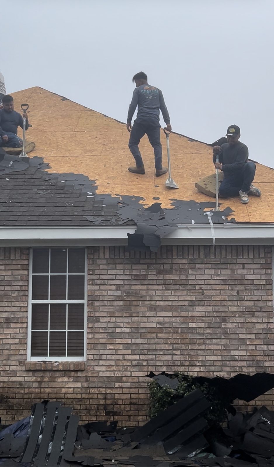 Crew stripping old shingles